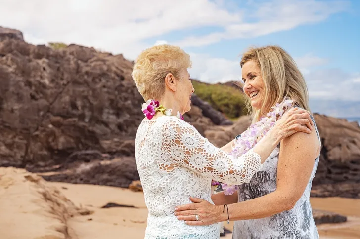 bride and mother of the bride embracing 