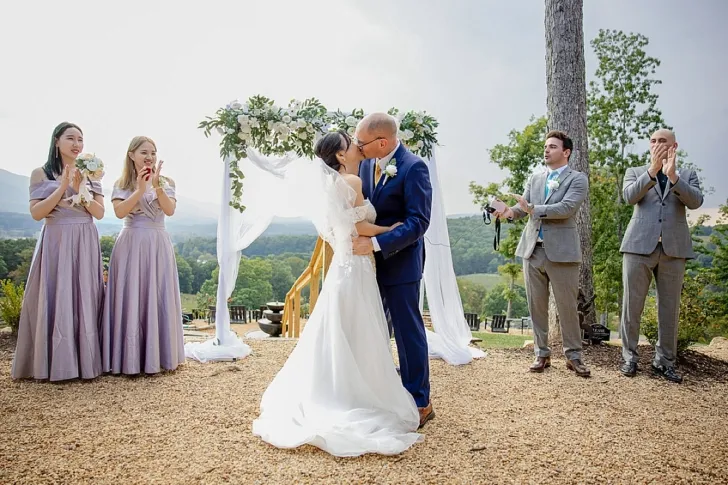 bride and groom kissing during wedding ceremony