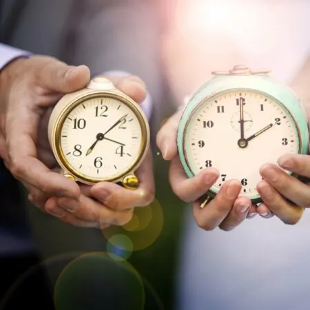wedding couple holding clocks - rushed wedding timeline