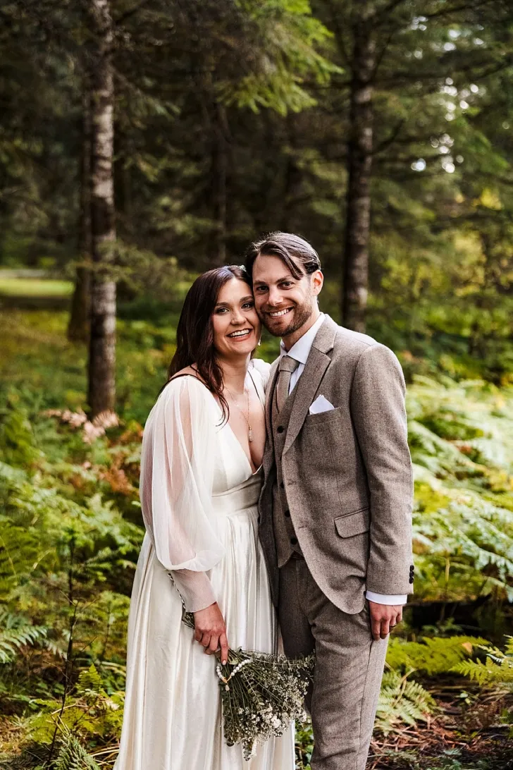 bride and groom smiling in Oregon forest