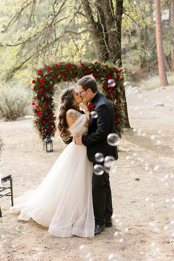 bride and groom kissing during wedding ceremony