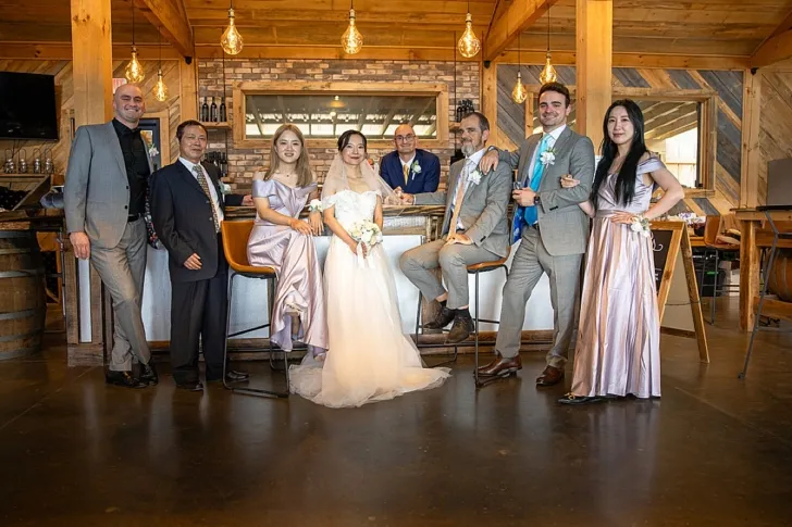 bride and groom posing with wedding party