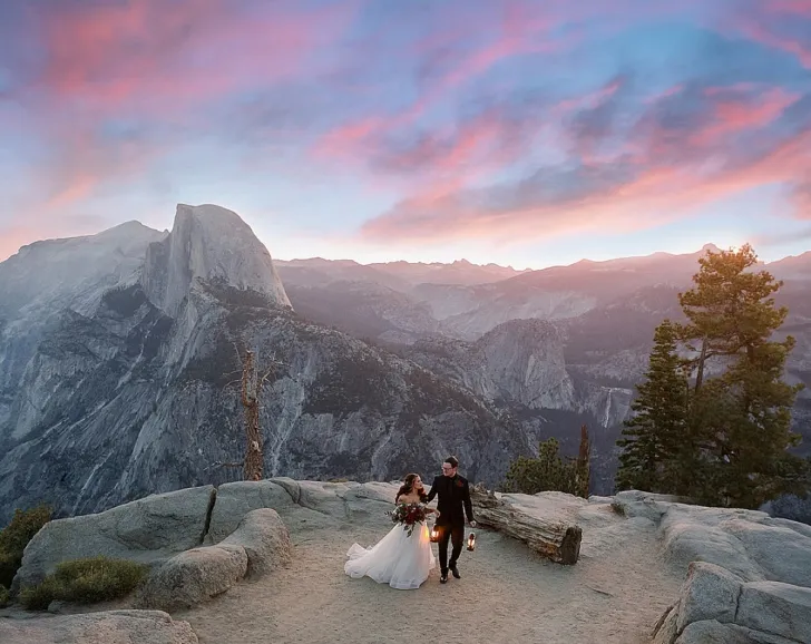 bride and groom walking while holding lanterns