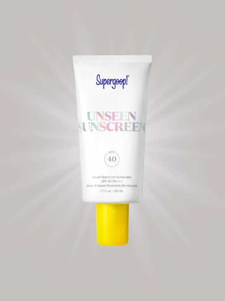 A tube of Supergoop! Unseen Sunscreen with SPF 40, featuring a white bottle with a yellow cap.