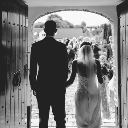 bride and groom exiting a door