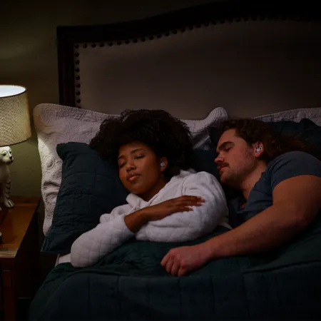 couple sleeping with sleep buds in ears