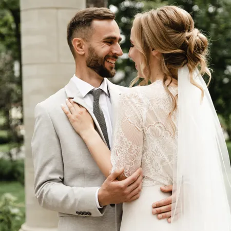 bride and groom smiling at each other on their wedding day
